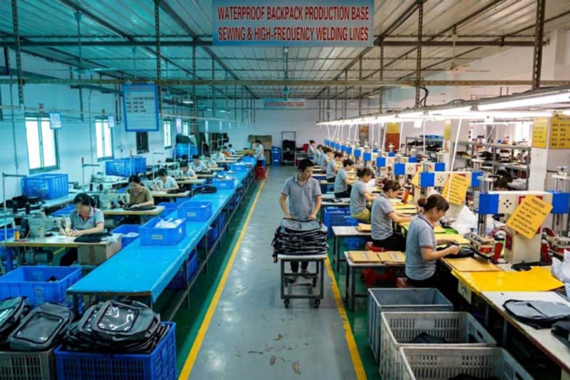 High-frequency welding press and industrial sewing line in a waterproof backpack factory